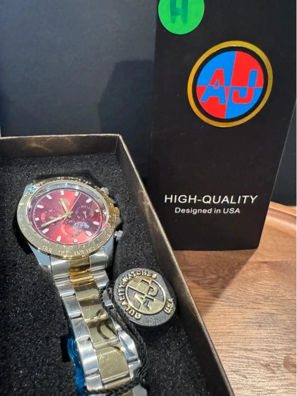 AJ watch, stainless steel, gold & silver toned, crimson red face